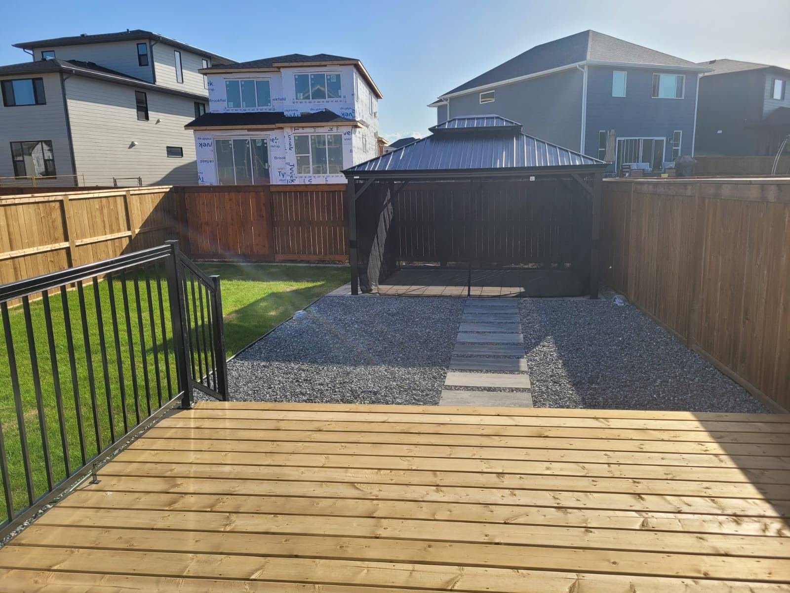 Gravel patio with gazebo and stepping stone path